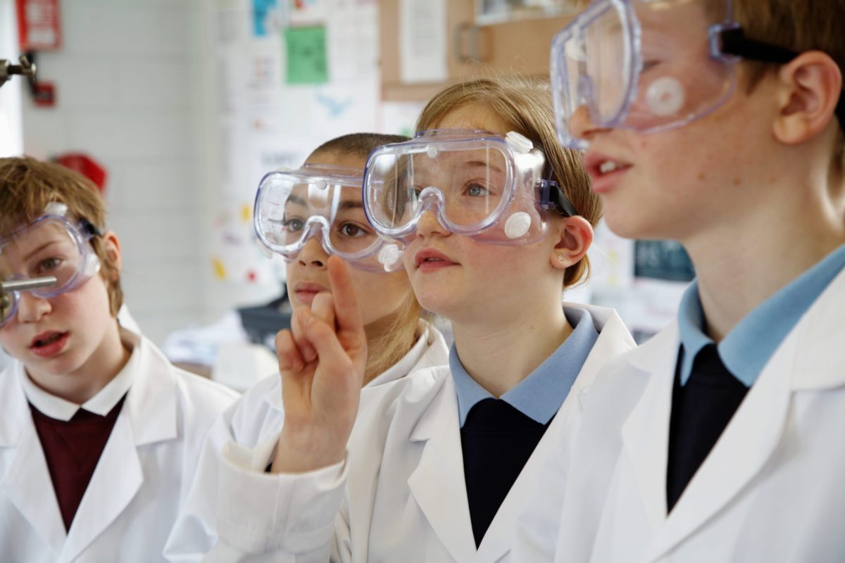 Two schoolgirls and two schoolboys (11-13) in a Science lesson.