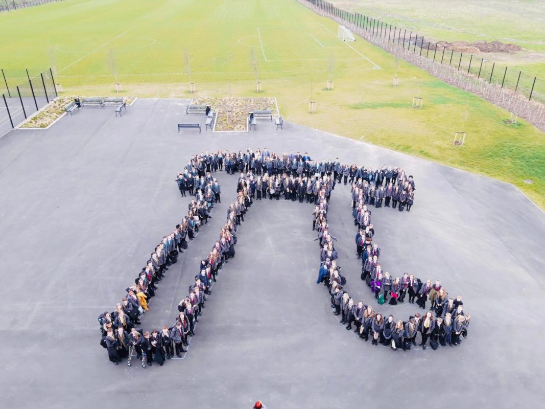 LAR students form the shape of the Pi symbol for an aerial photo in the school playground.