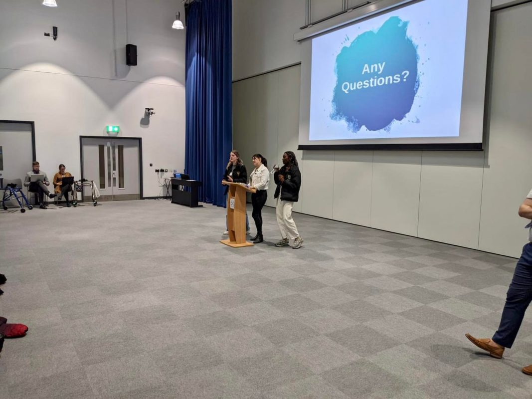 Members of staff are seen giving a presentation to students.