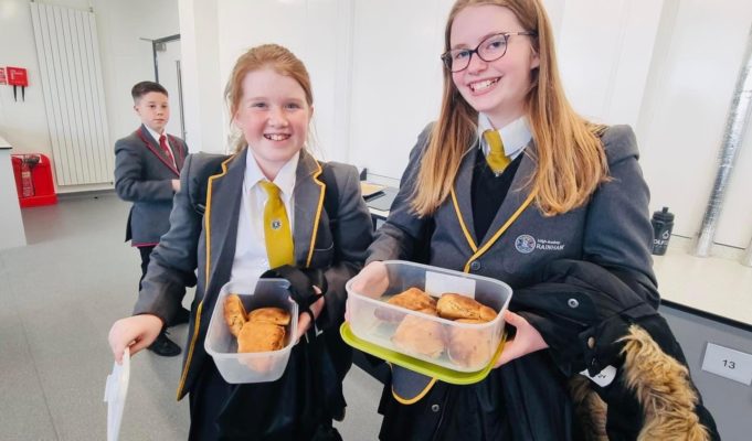LAR students are photographed smiling for the camera and showing off the Scones that they have baked.