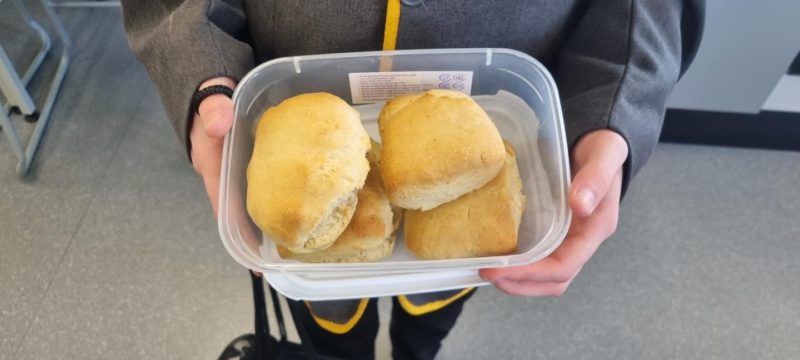 A photo of a plastic tub with Scones that have been baked by LAR students inside it.
